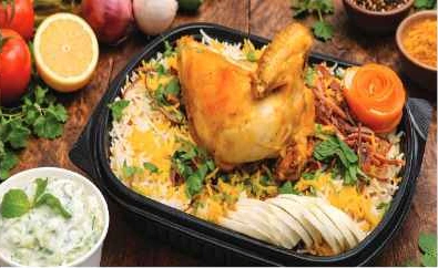 Chicken mandi served with rice and yogurt salad
